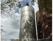 'Working at Heights' Prepairing to descend a blending tank to inspect the sight line.